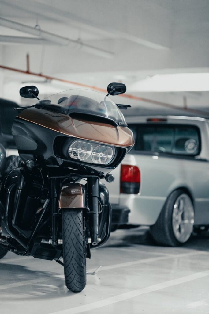 pexels photo 10196163 10196163 Motorcycle parked beside a vehicle in an indoor garage, showcasing urban transportation.